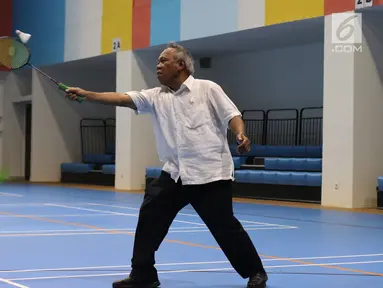 Menteri PUPR, Basuki Hadimuljono mengembalikan kok saat bertanding bulu tangkis disela kunjungannya di Training Facility Gelora Bung Karno Jakarta, Kamis (10/5). Basuki meninjau kesiapan fasilitas dan prasarana Asian Games 2018 (Liputan6.com/Angga Yuniar)