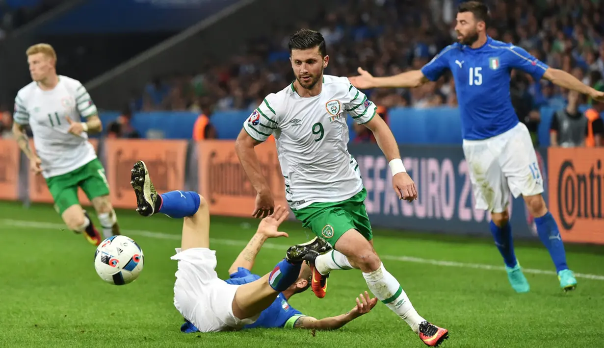 Pemain Irlandia, Shane Long (kanan), lolos dari hadangan pemain Italia, Leonardo Bonucci, pada laga Grup E Piala Eropa 2016 di Stade Pierre Mauroy, Lille, Kamis (23/6/2016) dini hari WIB. (AFP/Philippe Huguen)