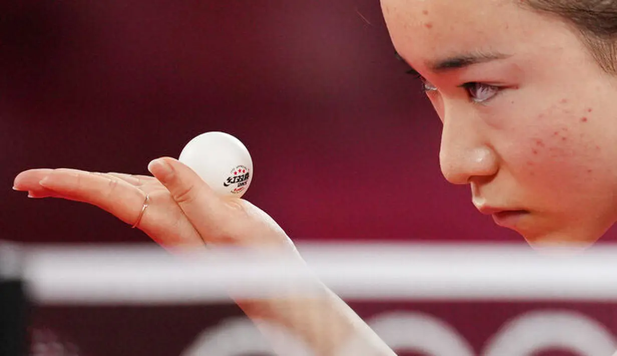 Petenis Jepang, Mima Ito, tampak serius memandang bola saat bertanding melawan atlet tenis meja Singapur, Yu Mengyu, pada perebutan medali perunggu tunggal putri di Olimpiade Tokyo 2020, Selasa, (27/7/2021). (Foto: AP/Kin Cheung)