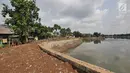 Seorang pria berjalan dekat tumpukan lumpur bercampur sampah dari proyek pengerukan situ Pedongkelan, Cimanggis, Depok, Rabu (28/11). Selain menimbulkan bau, banyaknya lumpur dan sampah membuat lingkungan warga tampak kumuh. (Liputan6.com/Herman Zakharia)