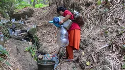 Penyandang tunanetra, Sujanah, berjalan menuju mata air Sumur Bendung di kawasan Gunung Batur, Kota Cilegon, Banten, Minggu (19/07/2026). (KLY/Arie Basuki)