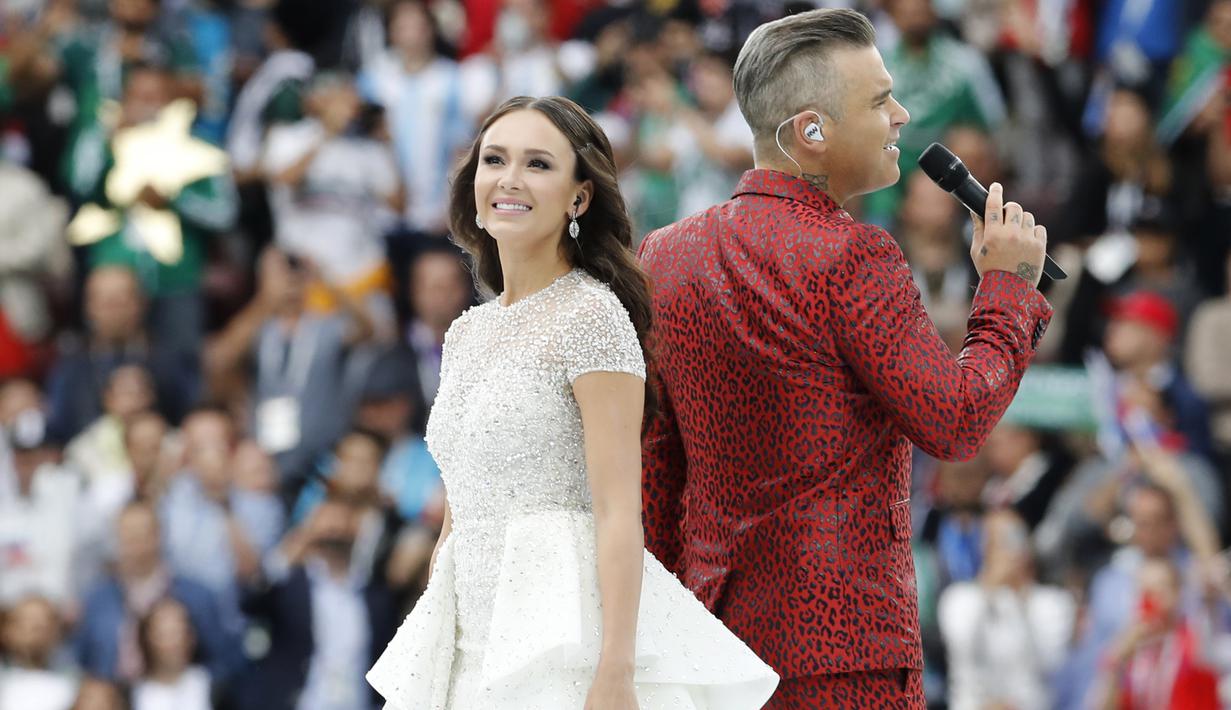 Penyanyi Rusia, Aida Garifullina, duet bersama penyanyi Inggris, Robbie Williams, saat pembukaan Piala Dunia di Stadion Luzhniki, Moskow, Kamis (14/6/2018). Laga pembuka Piala Dunia 2018 mempertemukan Rusia melawan Arab Saudi. (AP/Antonio Calanni)