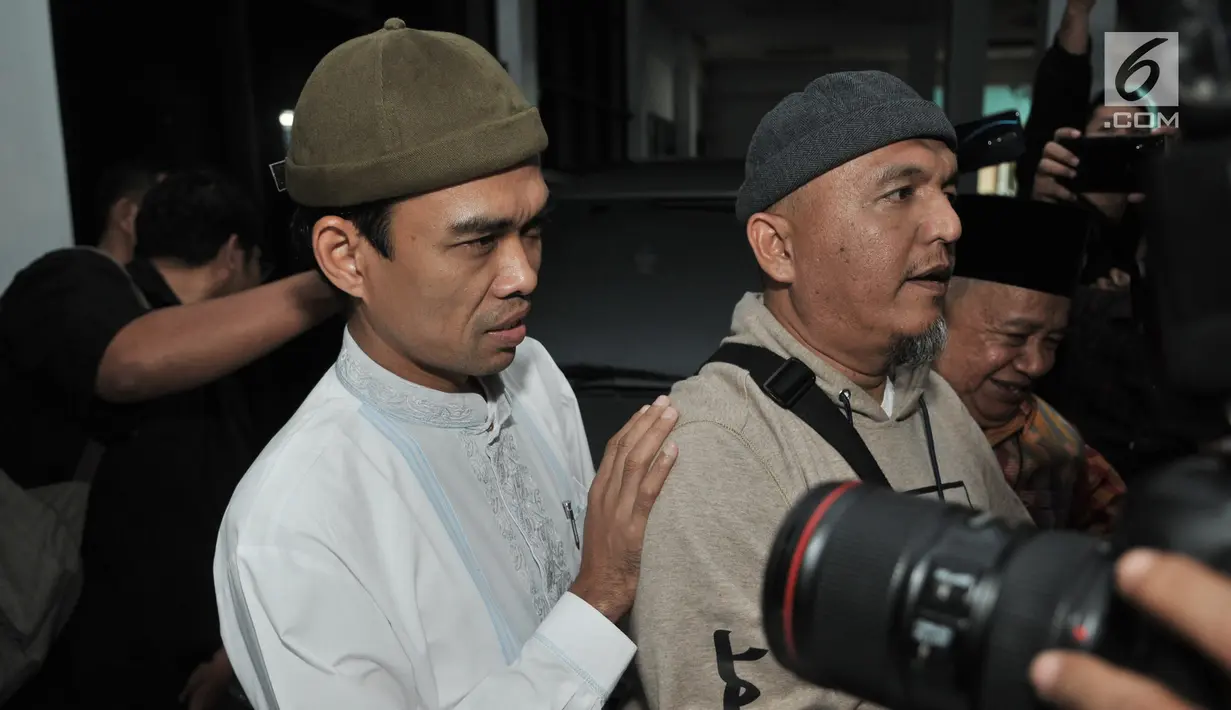 Ustaz Abdul Somad (UAS) berusaha menghindari kerumunan awak media setibanya di Kantor Majelis Ulama Indonesia (MUI), Jakarta, Rabu (21/8/2019). UAS memenuhi undangan MUI untuk menyampaikan klarifikasi mengenai video ceramahnya yang viral dan memicu polemik. (merdeka.com/Iqbal S Nugroho)