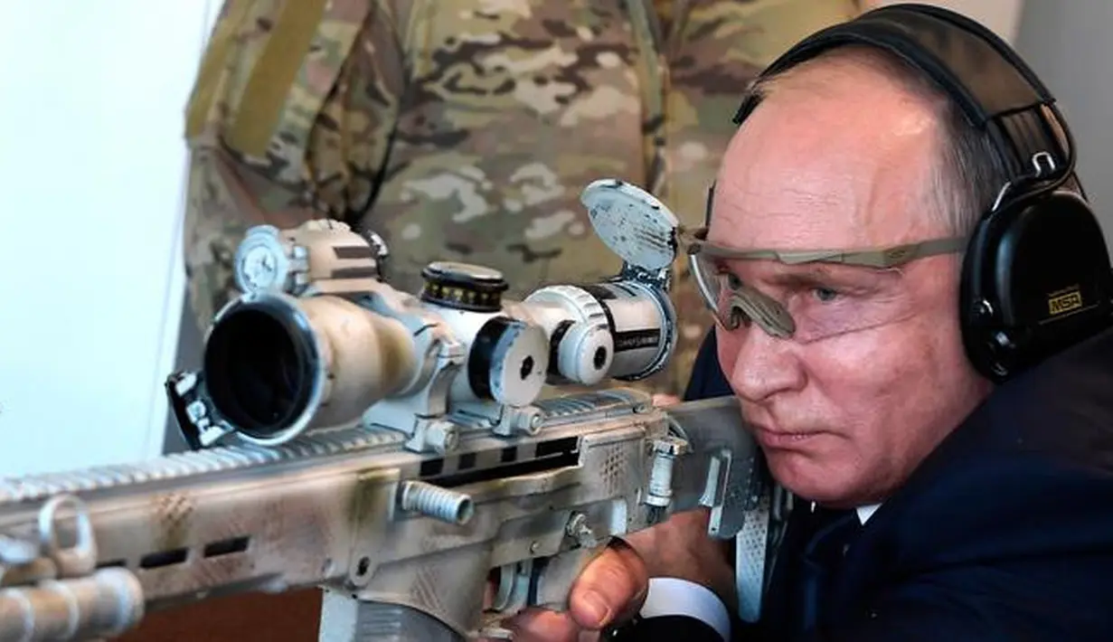 Presiden Rusia, Vladimir Putin menguji coba senapan sniper saat mengunjungi pameran Kalashnikov Concern di Patriot Park, luar Moskow, Rabu (19/9). Tembakan Putin menghantam target yang jaraknya 600 meter. (Alexei Nikolsky, Sputnik, Kremlin Pool via AP)