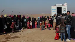 Sejumlah warga yang melarikan diri dari pertempuran antara pasukan Irak melawan kelompok militan ISIS mengantre untuk berobat di klinik di kamp pengungsian Sewdinan, Khazer, Irak, 3 Januari 2017. (AP Photo / Khalid Mohammed)