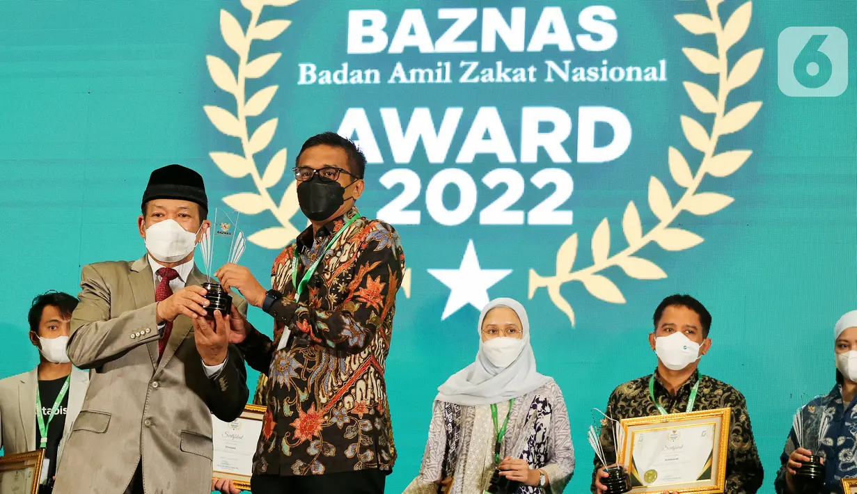 Ketua BAZNAS RI, Prof. Dr. KH. Noor Achmad memberikan penghargaan kepada Chief Marketing Officer LinkAja Wibawa Prasetyawan untuk kategori Mitra Pengumpulan Zakat via Financial Technology Terbaik di Jakarta, Senin (17/01/2022). (Liputan6.com/Fery Pradolo)