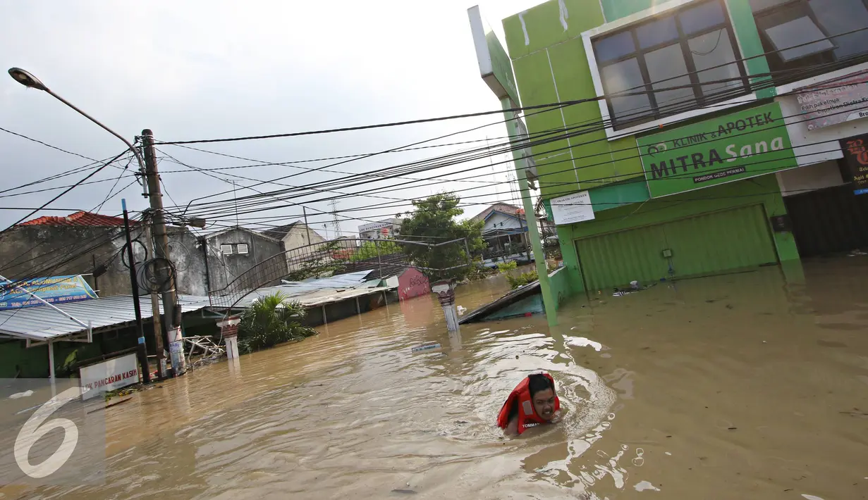 Warga menerobos banjir yang menggenangi Perumahan Pondok Gede Permai, Bekasi, Jawa Barat, Kamis (21/4). Banjir dengan ketinggian tiga meter yang berasal dari meluapnya Sungai Cikeas. (Liputan6.com/ Immanuel Antonius)
