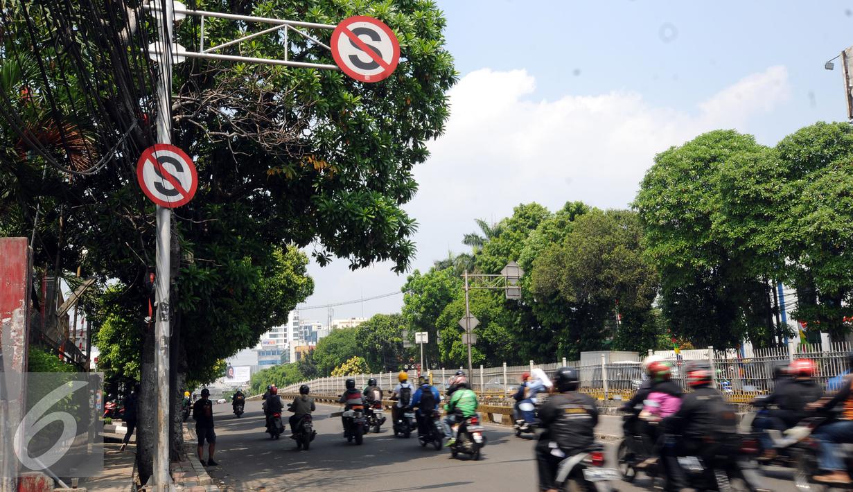 Pengendara melintas di bawah rambu larangan berhenti di Jalan Mampang Prapatan, Jakarta, Jumat (12/8). Pemprov DKI Jakarta secara bertahap akan mengganti rambu larangan parkir dan berhenti yang digunakan saat ini. (Liputan6.com/Helmi Fithriansyah)