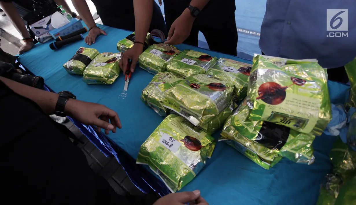 Petugas menunjukkan bukti narkoba jenis sabu dari jaringan Penang Malaysia sebelum dimusnahkan di Gedung BNN, Jakarta Timur, Jumat (26/1). Sebelum dimusnahkan barang bukti tersebut terlebih dahulu dilakukan uji laboratorium. (Liputan6.com/Arya Manggala)