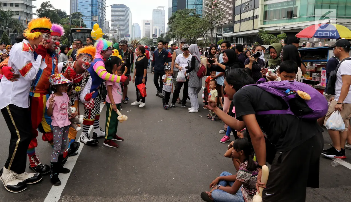 Komunitas dari Aku Badut Indonesia meramaikan kegiatan Car Free Day (CFD) di kawasan Thamrin, Jakarta, Minggu (6/1). Mereka melakukan atraksi akrobatik untuk menggalang dana bagi korban bencana tsunami Selat Sunda. (Liputan6.com/Johan Tallo)