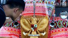 Seorang pria memegang burung Garuda Pancasila di mobil bercorak Ulos Mandailing yang akan digunakan acara ngunduh mantu Kahiyang-Bobby di Medan, Senin (20/11). (Liputan6.com/JohanTallo)