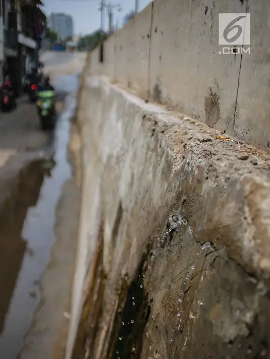 Air mengucur dari tanggul pengaman pantai yang bocor di kawasan Muara Baru, Jakarta, Selasa (11/12). Tanggul pengaman pantai untuk mencegah banjir rob di kawasan tersebut bocor karena tingginya volume pasang surut air laut. (Liputan6.com/Faizal Fanani)