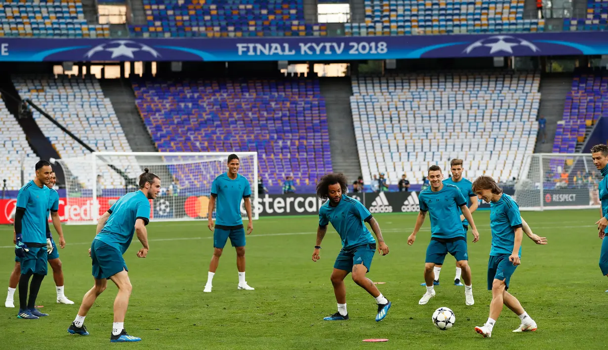 Pemain Real Madrid, Luka Modric mengoper bola selama sesi latihan menjelang final Liga Champions di NSC Olimpiyskiy Stadium, Kiev, Jumat (25/5). Final Liga Champions akan mempertemukan Real Madrid melawan wakil Inggris, Liverpool.  (AP/Pavel Golovkin)