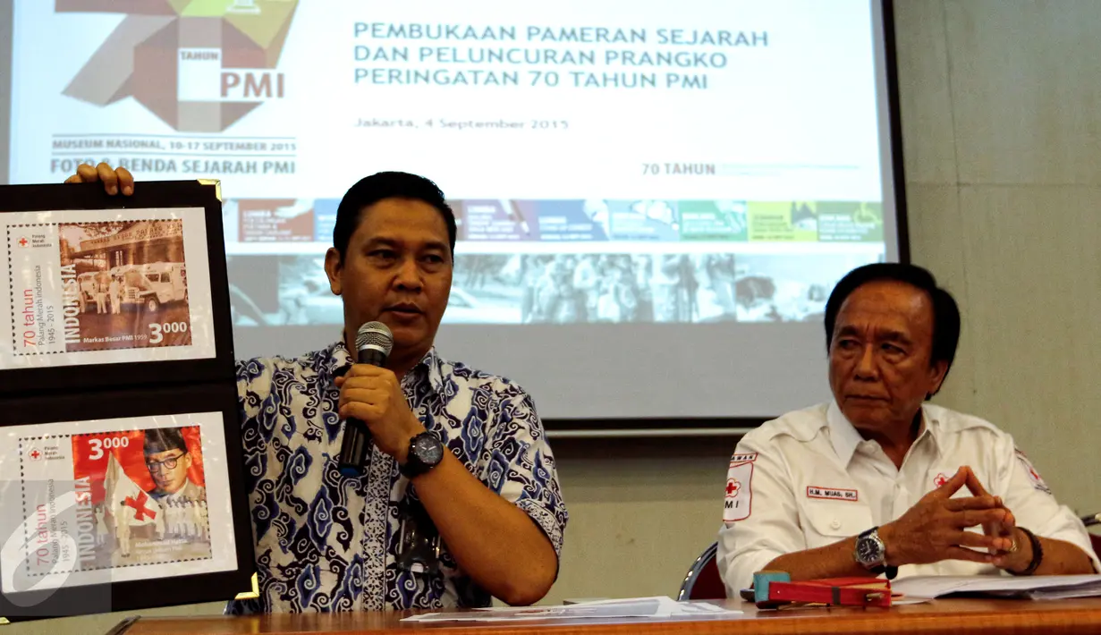 Direktur Filateli dan Properti PT Pos Indonesia, Tata Sugiarta (kiri) menunjukan contoh perangko HUT PMI ke-70 di Jakarta, Jumat (4/9). PMI akan pamerkan dan luncurkan perangko peringatan 70 tahun PMI pada 10 September 2015. (Liputan6.com/Yoppy Renato)