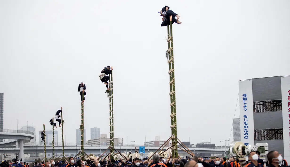 Anggota Asosiasi Pelestarian Pemadam Kebakaran Edo melakukan teknik pemadam kebakaran tradisional Jepang saat latihan pemadam kebakaran Tahun Baru di Tokyo, Jepang, 6 Januari 2022. (Behrouz MEHRI/AFP)