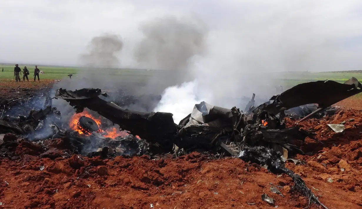 Puing-puing dari pesawat Su-22 milik Angkatan Udara Suriah di wilayah selatan Aleppo, Selasa (5/4). Sayap kelompok teroris Al-Qaeda di Suriah, Front al-Nusra, menembak jatuh jet SU-22 buatan Rusia tersebut menggunakan roket. (OMAR HAJ KADOUR/AFP)