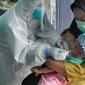 Paramedis melakukan swab test PCR kepada seorang anak di Puskesmas Kramat Jati, Jakarta Timur, Rabu (13/1/2020). Setiap harinya, Puskesmas Kramat Jati menyediakan kuota 300 swab test PCR  secara gratis untuk memutus mata rantai penyebaran COVID-19. (merdeka.com/Arie Basuki)