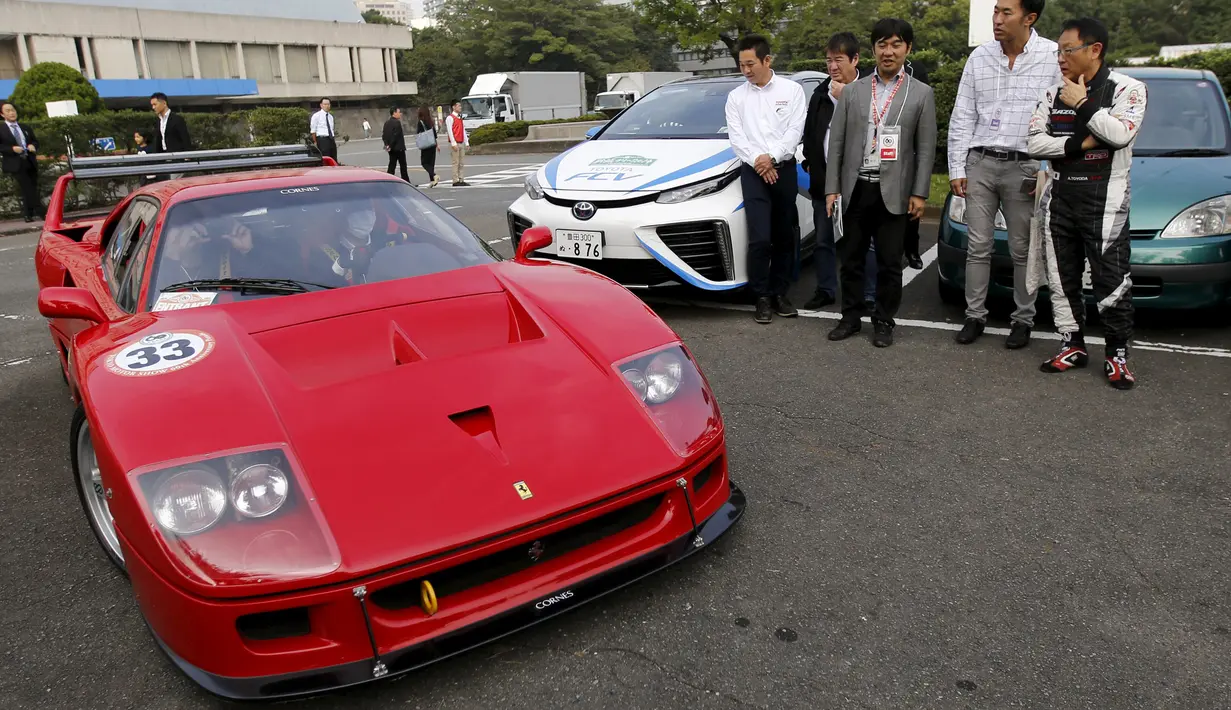 Presiden Toyota Motor Corp Akio Toyoda (kanan) saat melihat mobil Ferari 40 selama promosi Tokyo motor Show di Jepang, Sabtu (24/10/2015).  Nantinya lebih dari 76 merk mobil ternama akan meramaikan acara ini. (REUTERS/Toru Hanai)