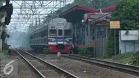 Warga melintasi rel kereta api di perlintasan kereta stasiun Pasar Minggu Baru, Jakarta, Senin (30/11). Untuk mengurangi angka kecelakaan PT KAI membangun JPO di Stasiun Pasar Minggu Baru. (Liputan6.com/Yoppy Renato)
