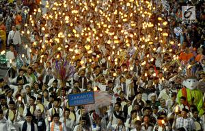 Umat muslim mengikuti pawai obor menyambut Tahun Baru Islam 1441 H pada acara Jakarta Muharram Festival di kawasan Bundaran HI, Jakarta, Sabtu (31/8/2019). Pawai yang diikuti 4000 peserta dimulai dari Jalan Merdeka Barat, Silang Monas, menuju Bundaran HI. (merdeka.com/Imam Bukhori)