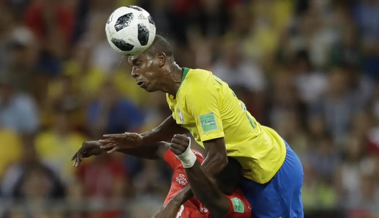 Gelandang Brasil, Fernandinho, berebut bola dengan striker Swiss, Breel Embolo, pada laga Grup E Piala Dunia di Rostov Arena, Rostov-on-Don, Minggu (17/6/2018). Kedua negara bermain imbang 1-1. (AP/Andre Penner)