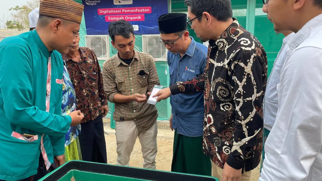 Group Head XL Axiata East Region Dodik Ariyanto (kemeja biru) merilis program budi daya maggot berbasis teknologi IoT untuk santri di Ponpes Miftahul Ulum Sekar Anyar, Pamekasan. (Liputan6.com/ Agustin Setyo Wardani)