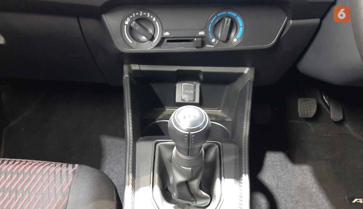 Panel pengontrol AC masih mengandalkan knob putar model kompor dengan pengaturan buka tutup ventilasi. Di depan tuas transmisi tersedia dua buah cup holder dan colokan 12V untuk mengisi daya gadget.