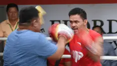 Petinju Filipina, Manny Pacquiao bertanding dengan teman masa kecilnya dan asisten pelatih lama Buboy Fernandez selama sesi pelatihan di gym di Manila, (17/5). Pacquiao akan bertanding melawan petinju Argentina Lucas Matthysse. (AFP Photo/Ted Aljibe)
