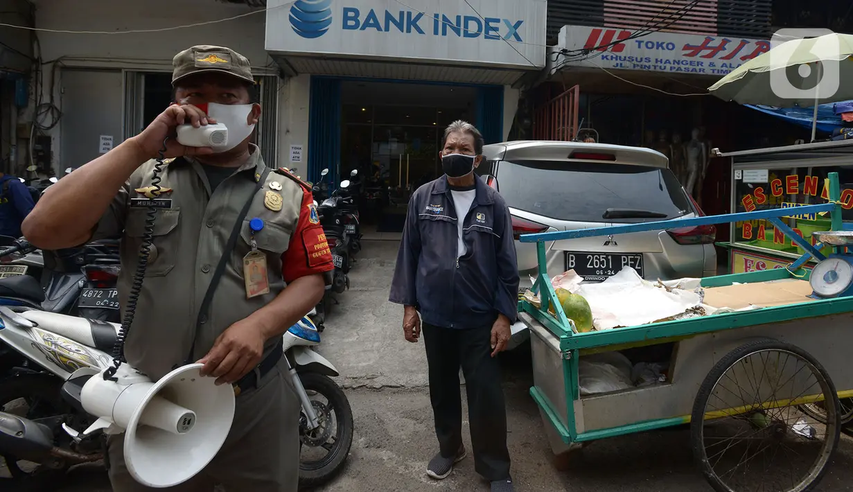 Petugas saat melakukan himbauan untuk memakai masker di Pasar Jatinegara, Kamis (10/9/2020). Pembagian masker serta himbauan  memakai masker saat keluar rumah dan ditempat Himb ini dilakukan untuk pencegahan penularan Covid-19 dimana kasus Covid-19 terus meningkat. (merdeka.com/Imam Buhori)