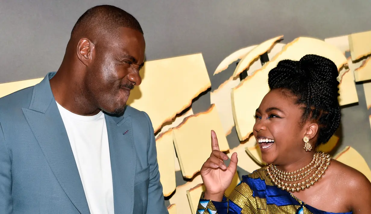 Aktor Idris Elba (kiri) dan Leah Jeffries berbagi momen saat menghadiri pemutaran perdana film Beast di Museum of Modern Art, New York, Amerika Serikat, 8 Agustus 2022. Leah mengenakan gelang emas tebal dan untaian mutiara di lehernya. (Photo by Evan Agostini/Invision/AP)