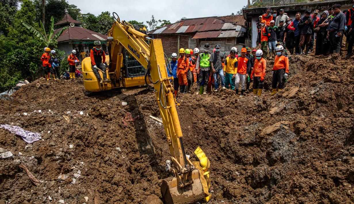 Tim pencari dan penyelamat gabungan terus melakukan upaya pencarian terhadap sejumlah warga yang dilaporkan hilang. Tampak dalam foto, petugas penyelamat berkumpul di sekitar ekskavator selama operasi pencarian korban di lokasi longsor di Desa Situkung, Banjarnegara, Jawa Tengah, pada Kamis 20 November 2025. (DEVI RAHMAN/AFP)