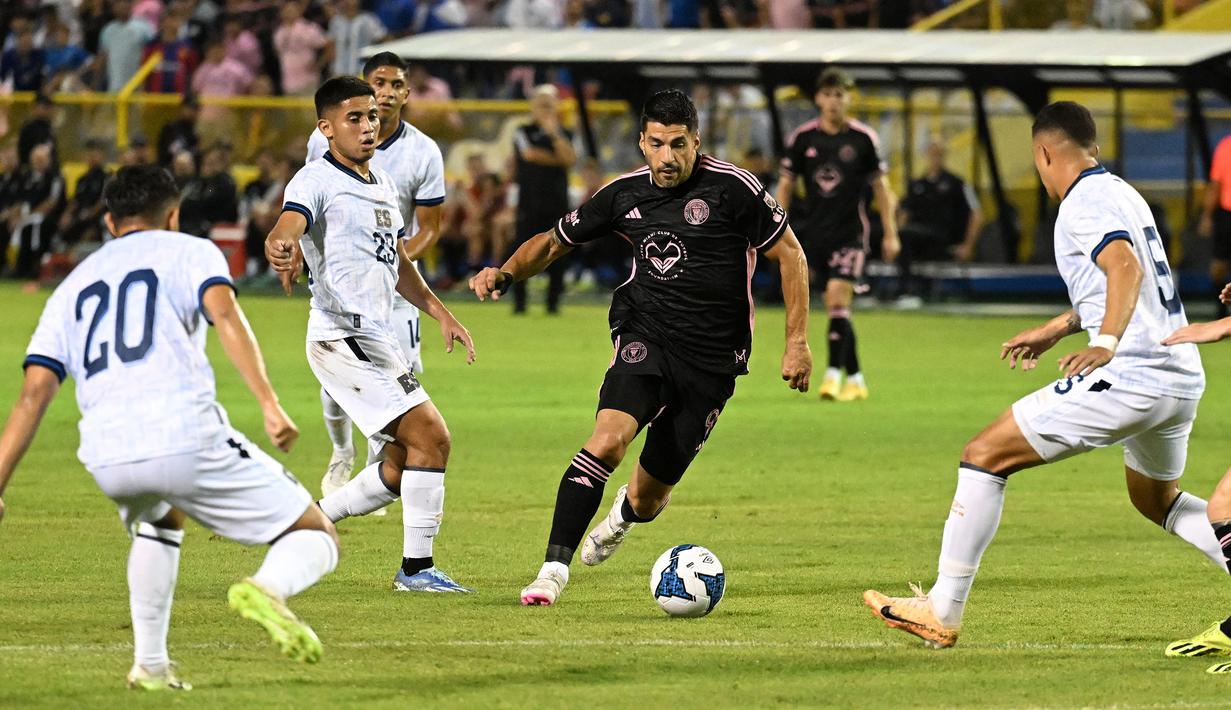 Pemain Inter Miami, Luis Suarez (tengah) berusaha melewati sejumlah pemain Timnas El Salvador pada laga persahabatan yang digelar di Kota San Salvador, El Salvador, Sabtu (20/01/2024) pagi WIB. (AFP/Marvin Recinos)