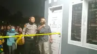 Petugas memasang garis polisi di kamar kontrakan yang menjadi lokasi bunuh diri. (Liputan6.com/M Syukur)