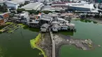 Foto udara suasana Kampung Apung di Kapuk, Jakarta, Kamis (2/11/2023). Kemarau panjang mengakibatkan air di Kampung Apung surut dan sejumlah makam terlihat kembali. (Liputan6.com/Herman Zakharia)