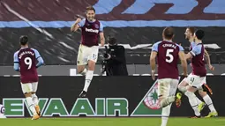Pemain West Ham United, Craig Dawson, merayakan gol ke gawang Leeds United pada laga Liga Inggris di Stadion London, Senin (8/3/2021). West Ham menang dengan skor 2-0. (Andy Rain/Pool Photo via AP)