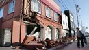 Seorang warga melihat kondisi bangunan yang rusak akibat gempa mengguncang Kota Abira di Hokkaido, Jepang, Kamis (6/9). Bencana ini telah menewaskan sedikitnya dua orang dan puluhan lainnya masih dalam proses pencarian. (Masanori Takei/Kyodo News via AP)