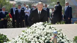 Ekspresi Presiden Rusia Vladimir Putin saat mengunjungi makam mendiang Presiden Uzbekistan Islam Karimov di kota bersejarah Samarkand, Selasa (6/9). Karimov meninggal di usia 78 tahun pada Jumat (2/9). (Sputnik/Kremlin/Alexei Druzhinin/ REUTERS)