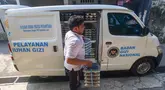 Petugas mendistribusikan ompremg makan bergizi gratis (MBG)  di Posyandu kawasan Limo, Depok, Jawa Barat, Selasa (14/7/2025).