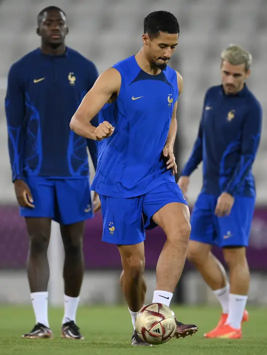Bek Prancis William Saliba mengikuti sesi latihan jelang laga semifinal Piala Dunia 2022 kontra Maroko di Al Sadd SC di Doha, Selasa (13/12/2022). Pertemuan Prancis vs Maroko di semifinal Piala Dunia 2022, merupakan yang pertama bagi kedua negara saling berhadapan di putaran final FIFA Wordl Cup. (FRANCK FIFE / AFP)