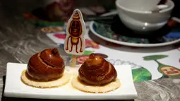 Roti gandum goreng yang bentuknya seperti cangkang keong di restoran Dim Sum Icon, Hong Kong , China, (25). Berbagai sajian makanan disini dihiasi dengan karakter wajah dan imut yang membuat kita tak tega memakannya. (REUTERS / Bobby Yip)