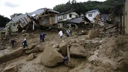 Puluhan rumah terkubur lumpur dan batu akibat tanah longsor di wilayah perumahan di Asaminami, Hiroshima, Jepang, (20/8/2014). Tampak, beberapa petugas penyelamat berusaha melakukan evakuasi korban. (REUTERS/Toru Hanai)