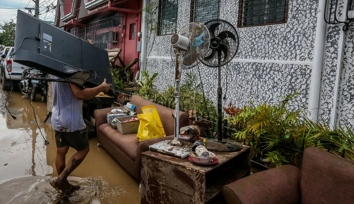 Seorang warga menyelamatkan harta benda usai hujan deras yang dibawa Topan Goni memicu terjadinya banjir di Provinsi Batangas, Filipina, 2 November 2020. Hingga 2 November 2020, jumlah korban jiwa akibat Topan Goni yang melanda bagian selatan Luzon bertambah menjadi 16 orang. (Xinhua/Rouelle Umali)