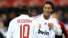 AC. Milan's Brazilian forward Ronaldinho celebrates after scoring a goal with midfielder Clarence Seedorf during an UEFA Cup football match AC Milan vs Braga at San Siro Stadium in Milan on November 06, 2008. AFP PHOTO / GIUSEPPE CACACE