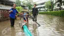 Petugas menggunakan pompa penyedot banjir untuk menguras genangan banjir di kawasan Kemang, Jakarta, Selasa (4/10). Pihak terkait sudah menurunkan empat pompa untuk menyurutkan banjir ini. (Liputan6.com/Gempur M Surya)