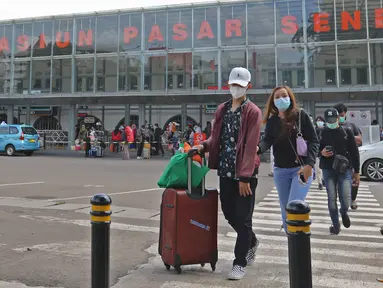 Penumpang kereta api Dharmawangsa Surabaya Pasarturi–Pasar Senen tiba di stasiun Senen, Jakarta, Minggu (3/01/2021). PT KAI Daop 1 memprediksi puncak arus balik libur Natal dan Tahun Baru 2021 terjadi pada 3-4 Januari 2020. (Liputan6.com/Herman Zakharia)