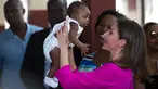 Ratu Spanyol Letizia menggendong seorang bayi laki-laki dalam kunjungannya ke rumah sakit di daerah kumuh Soleil, Haiti, 23 Mei 2018. Ini merupakan kunjungan pertama Ratu Letizia ke negara termiskin di benua Amerika tersebut. (AP/Dieu Nalio Chery)