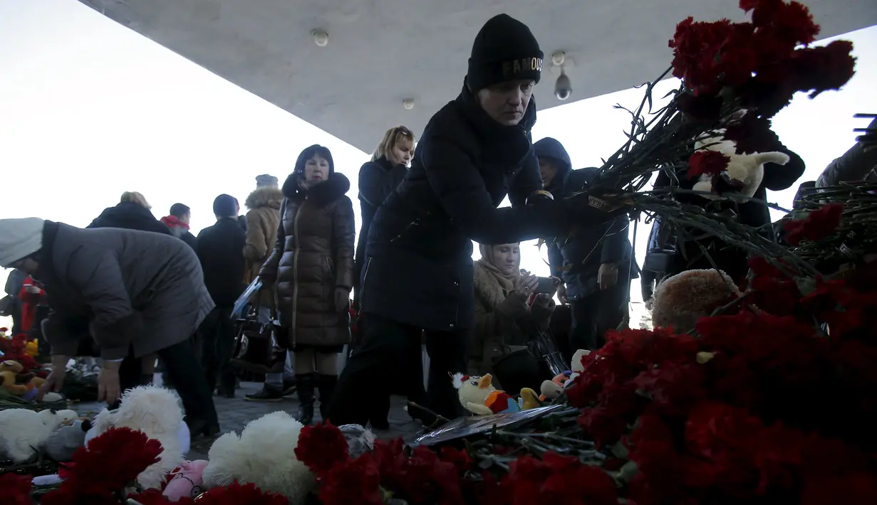 Warga meletakkan karangan bunga untuk mengenang korban jatuhnya pesawat maskapai Flydubai, di luar Bandara Rostov-on-Don, Rusia, Minggu (20/3). Insiden itu menewaskan seluruh penumpang dan kru yang berjumlah 62 orang. (REUTERS/Maxim Shemetov)