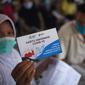 Warga menunjukkan kartu vaksinasi Covid-19 usai mengikuti vaksin di SDN Grogol Utara 09 Pagi, Jakarta, Sabtu (28/8/2021). Vaksinasi yang diikuti 1.000 peserta merupakan kolaborasi yang sejalan dengan semangat RYTHM dari QNet dalam meningkatkan kesehatan masyarakat Indonesia. (Liputan6.com/HO/QNet)