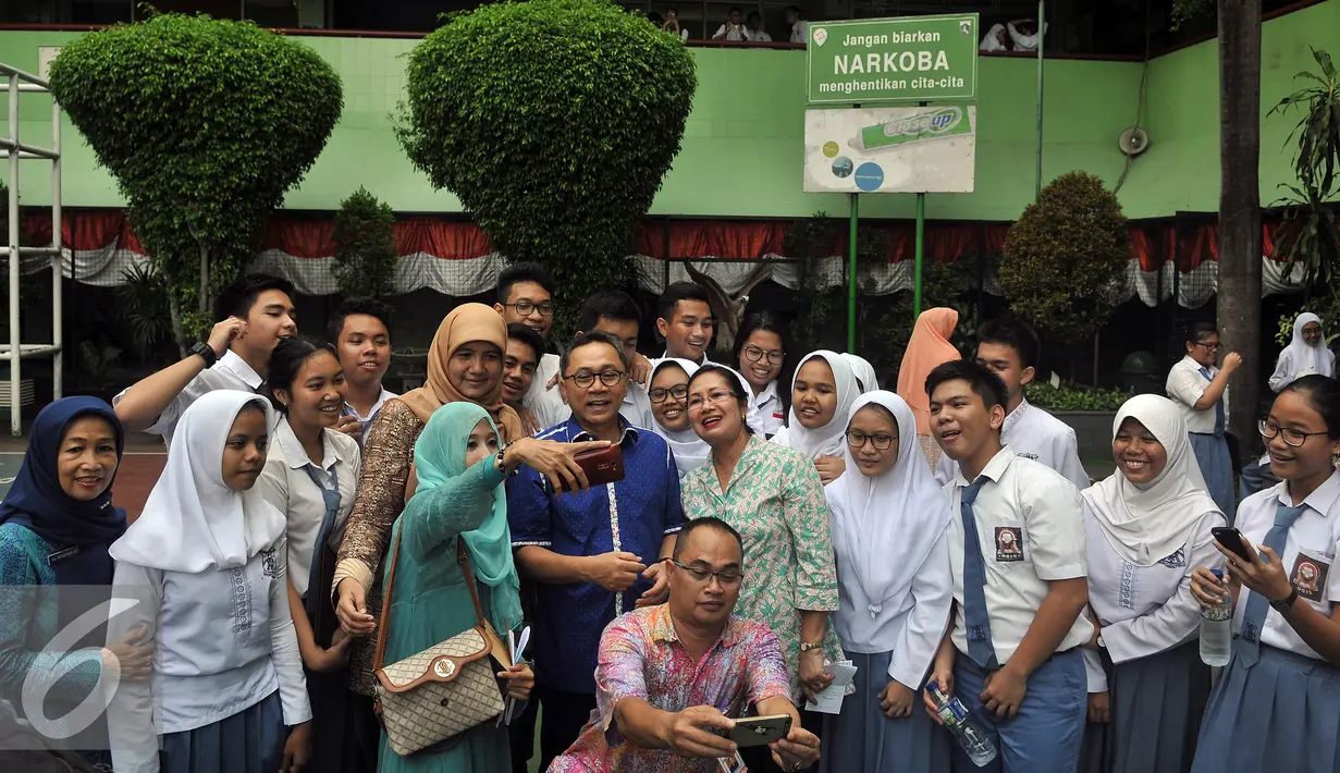 Ketua MPR Zulkifli Hasan selfie bersama pengajar dan siswa SMAN 68, Jakarta, Jumat (19/8). Kedatangan Zulkifli dalam rangka sosialisasi bahaya penyalahgunaan narkoba. (Liputan6.com/Johan Tallo) 