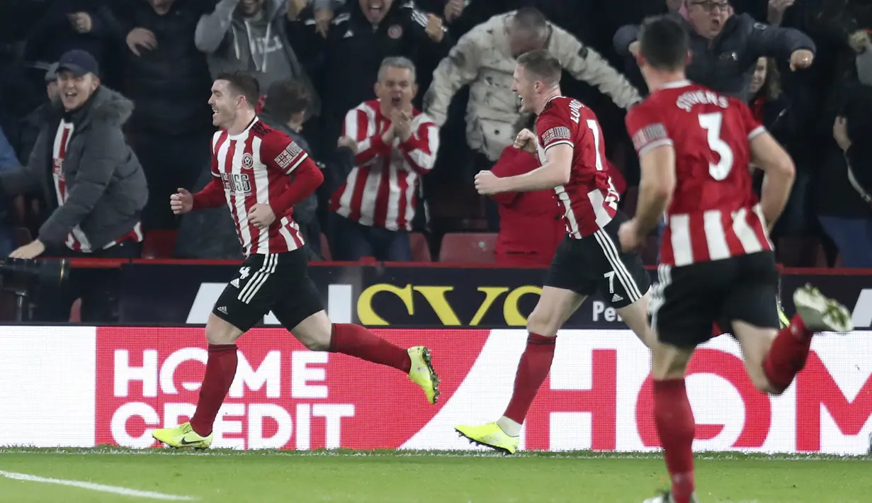 Gelandang Sheffield United, John Fleck (kiri) berselebrasi usai mencetak gol ke gawang Manchester United pada pertandingan lanjutan Liga Inggris di Stadion Bramall Lane (24/11/2019). MU bermain imbang 3-3 atas Sheffield Unite. (AP Photo/Jon Super)